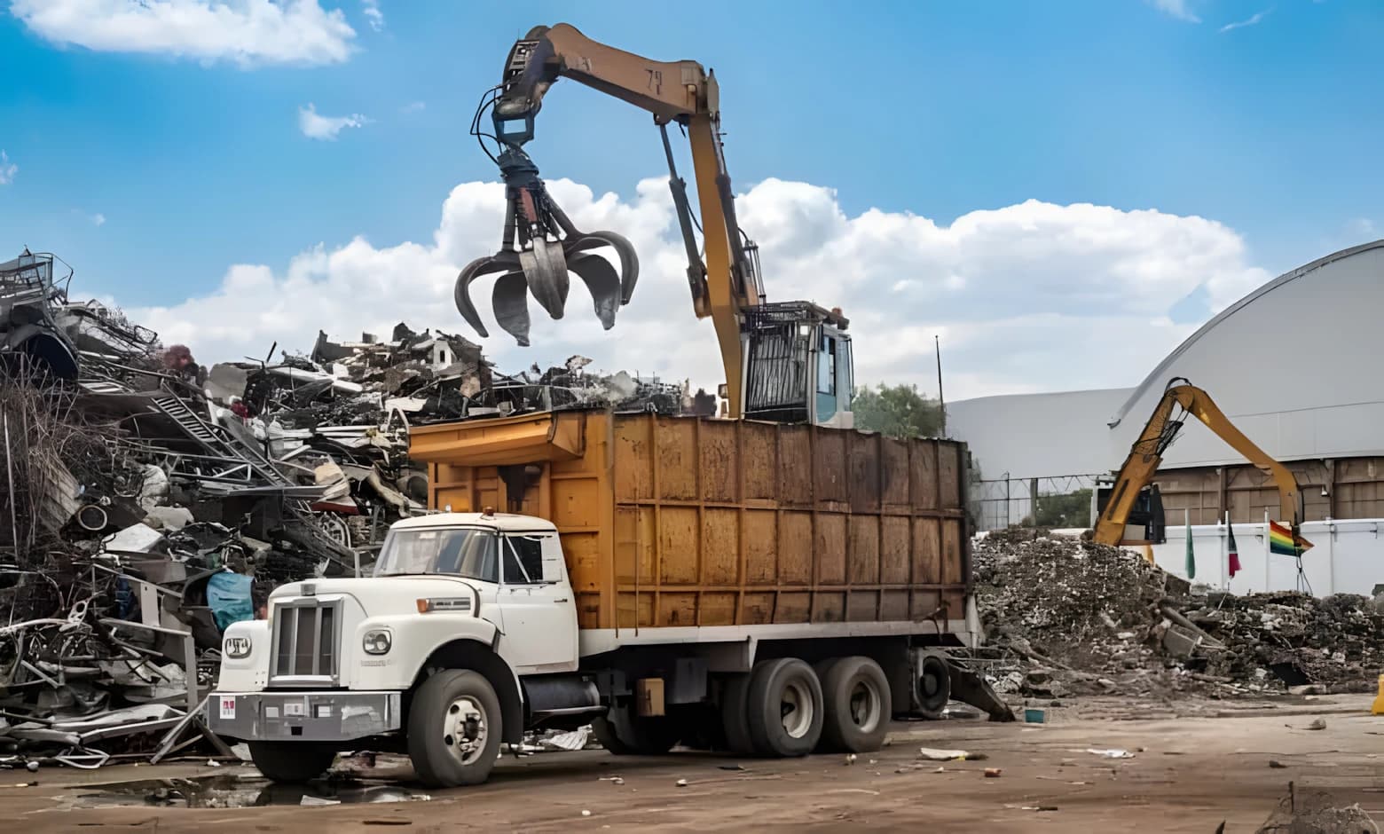 Grapple crane loading scrap metal at a recycling yard